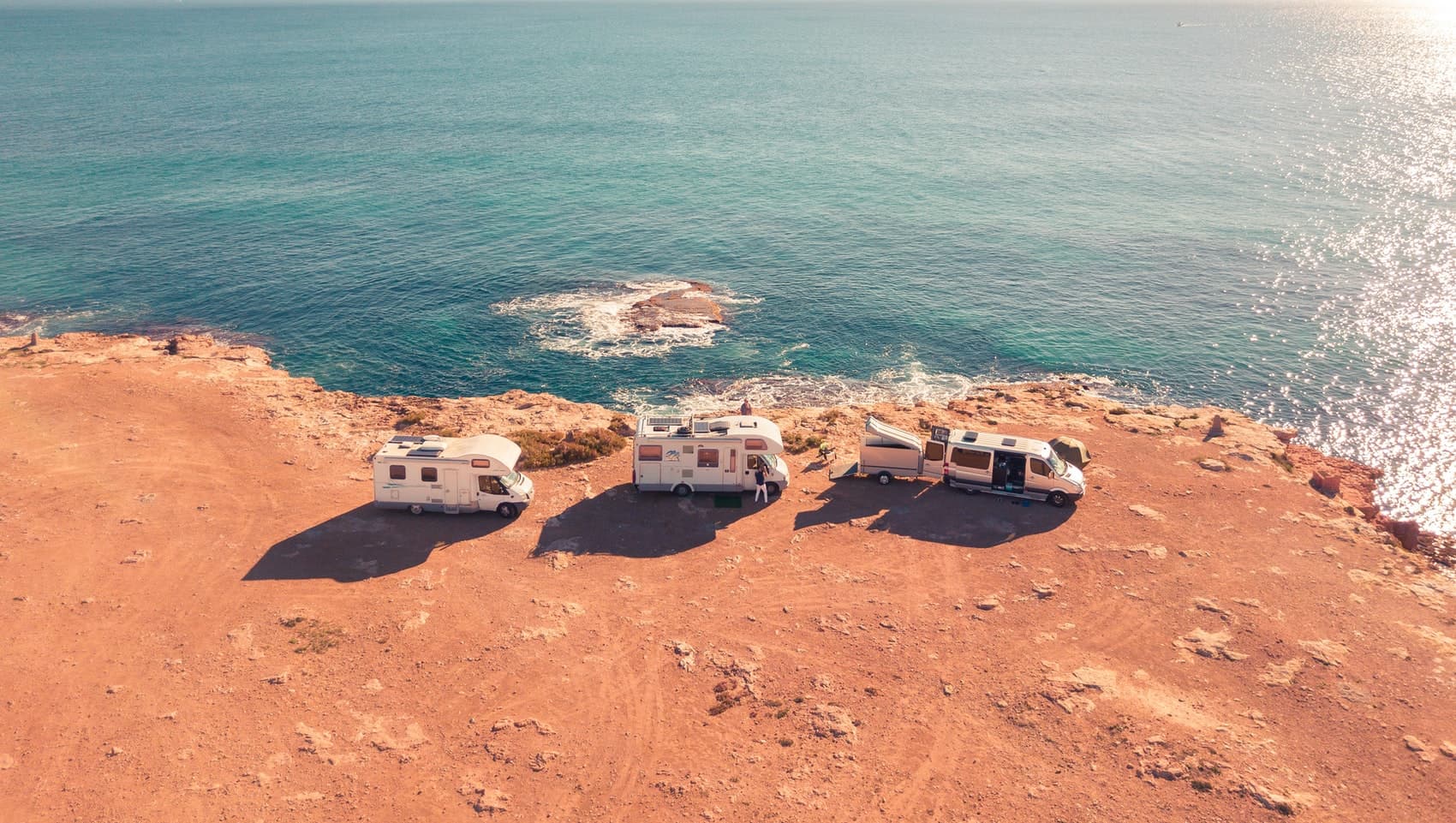 Three RVs on coast