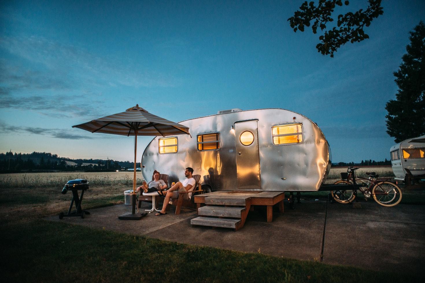 Couple sitting by their camper