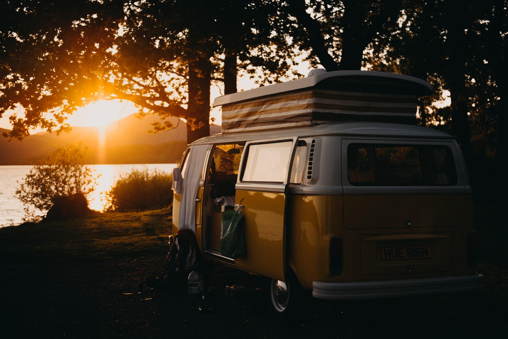 Van on lake at sunset