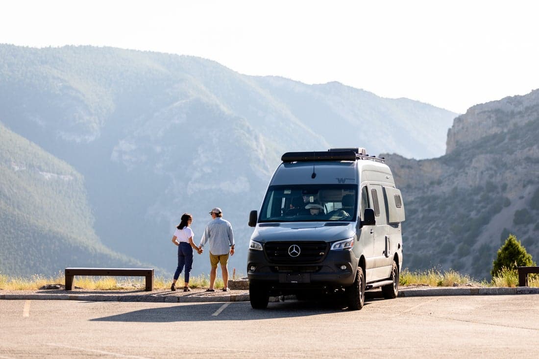 Couple with RV and mountains